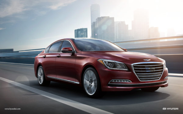 Red Hyundai Genesis luxury sedan driving down street