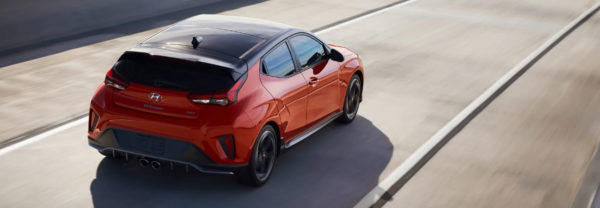 The 2019 Hyundai Veloster driving down the road